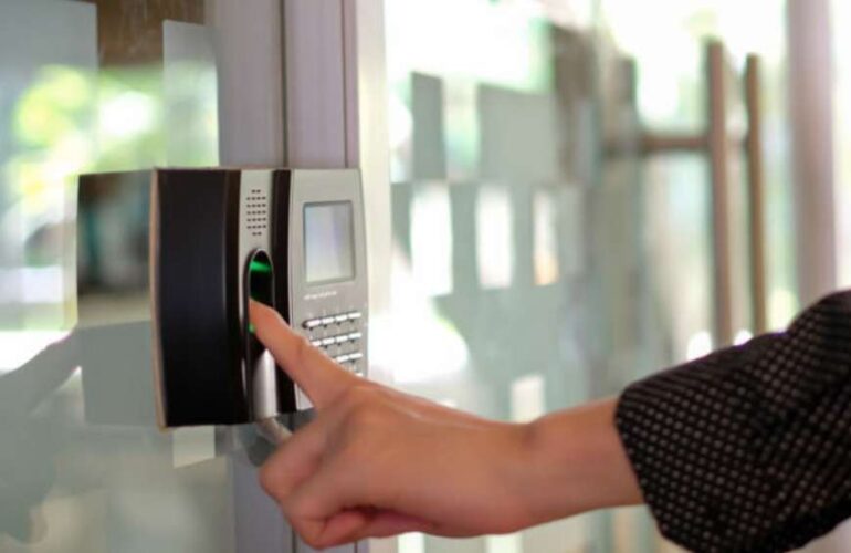 Biometric attendance machine installed in a warehouse for accurate employee time tracking.