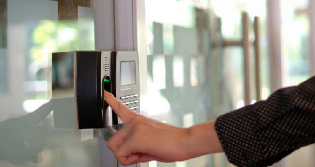 Biometric attendance machine installed in a warehouse for accurate employee time tracking.