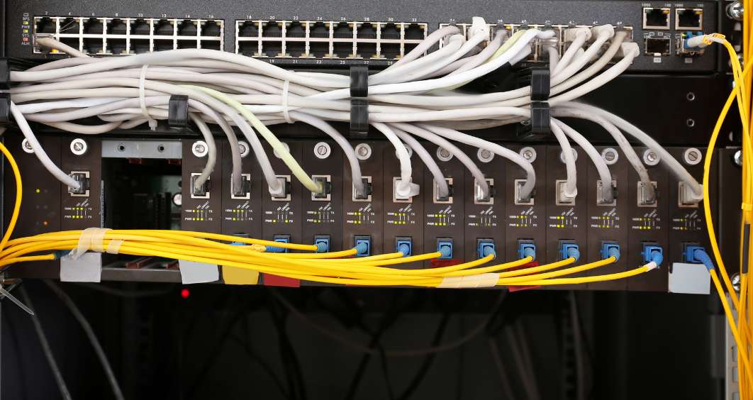 Neatly organized structured cabling in an IT room, ensuring efficient network performance.